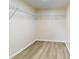 Spacious walk-in closet featuring wood-look floors and adjustable shelving for efficient storage and organization at 415 Parkdale Dr # 2F, Charleston, SC 29414