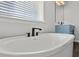 Modern bathroom with a sleek soaking tub, a stylish faucet, and abundant natural light at 424 Carrara Dr, Summerville, SC 29486