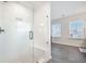 Bright bathroom with glass shower featuring a built-in seat and gray tiled flooring at 424 Carrara Dr, Summerville, SC 29486