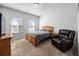 Comfortable bedroom featuring natural light from two windows and a cozy armchair at 424 Carrara Dr, Summerville, SC 29486