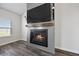 Fireplace with a mounted TV, hardwood floors, and a window at 424 Carrara Dr, Summerville, SC 29486