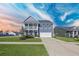Charming two-story home featuring a welcoming porch, well-manicured lawn, and a two-car garage at 424 Carrara Dr, Summerville, SC 29486