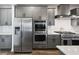 A modern kitchen featuring stainless steel appliances and sleek gray cabinetry at 424 Carrara Dr, Summerville, SC 29486