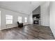 Spacious living room featuring hardwood floors and a fireplace with a mounted television at 424 Carrara Dr, Summerville, SC 29486