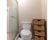 Bathroom with a toilet, shower, tile floor and a tower of woven baskets for storage at 4407 S Shirley Dr, North Charleston, SC 29418