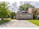 Charming brick home features a spacious parking area and mature trees at 4407 S Shirley Dr, North Charleston, SC 29418