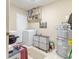 Bright laundry room featuring a washing machine, dryer, shelving, and water heater at 4407 S Shirley Dr, North Charleston, SC 29418
