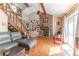 Inviting living room with exposed brick, wood floors, and natural lighting at 4407 S Shirley Dr, North Charleston, SC 29418