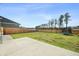 Large fenced backyard featuring a concrete patio and green grass at 490 Rowley Ln, Summerville, SC 29486