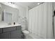 Clean bathroom featuring gray cabinets, a shower with white curtain and modern fixtures at 490 Rowley Ln, Summerville, SC 29486