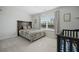 Comfortable bedroom with a patterned bedspread, window view, and adjacent baby crib at 490 Rowley Ln, Summerville, SC 29486
