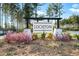 Lochton community entrance sign surrounded by blooming flowers and lush greenery, welcoming residents and guests at 490 Rowley Ln, Summerville, SC 29486