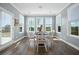 Bright dining area featuring a round table, four chairs, and plenty of natural light through large windows at 490 Rowley Ln, Summerville, SC 29486