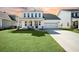 Charming two-story home featuring manicured lawn, two-car garage, and inviting front porch at 490 Rowley Ln, Summerville, SC 29486