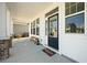 Charming front porch featuring white columns, a welcome mat and wooden bench at 490 Rowley Ln, Summerville, SC 29486