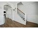 Interior hallway with staircase, luxury vinyl plank flooring, and decorative wall accents at 490 Rowley Ln, Summerville, SC 29486