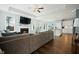 Open concept living room with a fireplace and view into the modern white kitchen at 490 Rowley Ln, Summerville, SC 29486