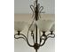 Close up of dining room chandelier with white glass lamps and bronze colored features at 505 Sunnyside Way, Summerville, SC 29485