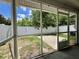 View of backyard through a screened in porch with white posts, and concrete flooring at 505 Sunnyside Way, Summerville, SC 29485