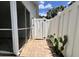 View of a screened porch, brick patio and a gated side yard with white privacy fence at 505 Sunnyside Way, Summerville, SC 29485