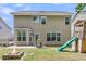 Exterior back of home featuring a fire pit, playground set, and patio at 5228 Fallow Fawns Rd, Hollywood, SC 29449