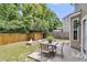 Backyard patio with a fire pit, dining table, and fenced yard at 5228 Fallow Fawns Rd, Hollywood, SC 29449