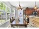The dining room features natural lighting, hardwood floors, and a rustic wooden table at 5228 Fallow Fawns Rd, Hollywood, SC 29449