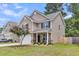 Inviting two-story home with a manicured lawn, showcasing stone accents and an attached two-car garage at 5228 Fallow Fawns Rd, Hollywood, SC 29449