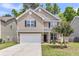 Charming two-story home with a manicured lawn, featuring stone accents and a spacious two-car garage at 5228 Fallow Fawns Rd, Hollywood, SC 29449