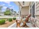 Cozy front porch featuring comfortable seating, beautiful landscaping, and inviting curb appeal at 5228 Fallow Fawns Rd, Hollywood, SC 29449