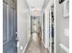Bright hallway with wood floors, leading to various rooms with a view to the backyard at 5228 Fallow Fawns Rd, Hollywood, SC 29449