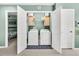 The laundry room features modern washer and dryer units, storage cabinets, and a clean, organized space at 5228 Fallow Fawns Rd, Hollywood, SC 29449