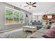 Inviting living room with a large window, hardwood floors, ceiling fan and comfortable blue sofa at 5228 Fallow Fawns Rd, Hollywood, SC 29449