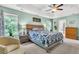 This comfortable main bedroom features carpet, a ceiling fan, windows and an attached bath at 5228 Fallow Fawns Rd, Hollywood, SC 29449