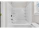 Clean white bathroom with a shower-tub and white tile surround, offering a bright and fresh space at 5376 Copley Cir, Summerville, SC 29485