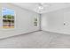 Bright bedroom with carpet, two windows, and a ceiling fan at 5376 Copley Cir, Summerville, SC 29485