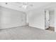 Large carpeted bedroom with a ceiling fan and a view into the attached bathroom and walk-in closet at 5376 Copley Cir, Summerville, SC 29485
