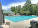 Large community pool with plenty of lounge chairs, tables, and umbrellas at 5376 Copley Cir, Summerville, SC 29485