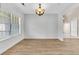Dining room featuring hardwood floors, large window with blinds, and a modern chandelier at 5376 Copley Cir, Summerville, SC 29485