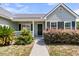 Welcoming front entrance featuring a cozy porch, neat landscaping, and classic window shutters at 5376 Copley Cir, Summerville, SC 29485