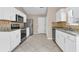 Bright kitchen featuring white cabinets, stainless steel appliances, granite countertops, and tile backsplash at 5376 Copley Cir, Summerville, SC 29485