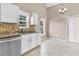 Well-lit kitchen featuring white cabinets, granite countertops, stainless steel dishwasher, and large windows at 5376 Copley Cir, Summerville, SC 29485