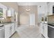 Open kitchen with white cabinets, granite countertops, stainless steel stove, and an adjacent dining area at 5376 Copley Cir, Summerville, SC 29485