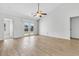 Bright open-plan living area with wood flooring, ceiling fan, and sliding glass doors to the backyard at 5376 Copley Cir, Summerville, SC 29485