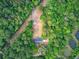 Aerial view of a property with a home surrounded by lush greenery and trees at 5669 Sands Rd, Hollywood, SC 29449