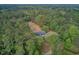 A high-angle shot reveals a cozy home embraced by verdant trees, emphasizing tranquility and seclusion at 5669 Sands Rd, Hollywood, SC 29449