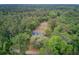 This aerial perspective shows a charming home nestled in a green forest, offering a serene retreat at 5669 Sands Rd, Hollywood, SC 29449