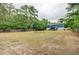 Expansive fenced backyard with home in the background, ideal for recreation and outdoor living at 5669 Sands Rd, Hollywood, SC 29449