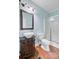 Bathroom featuring a unique vessel sink on a dark vanity, a large framed mirror, and a glass shower with white tile at 5669 Sands Rd, Hollywood, SC 29449