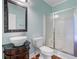 Quaint bathroom features a vessel sink on a vintage vanity, with a framed mirror and glass-enclosed shower at 5669 Sands Rd, Hollywood, SC 29449